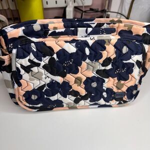 The item shown is a Lug Wings SE Crossbody bag in a floral pattern